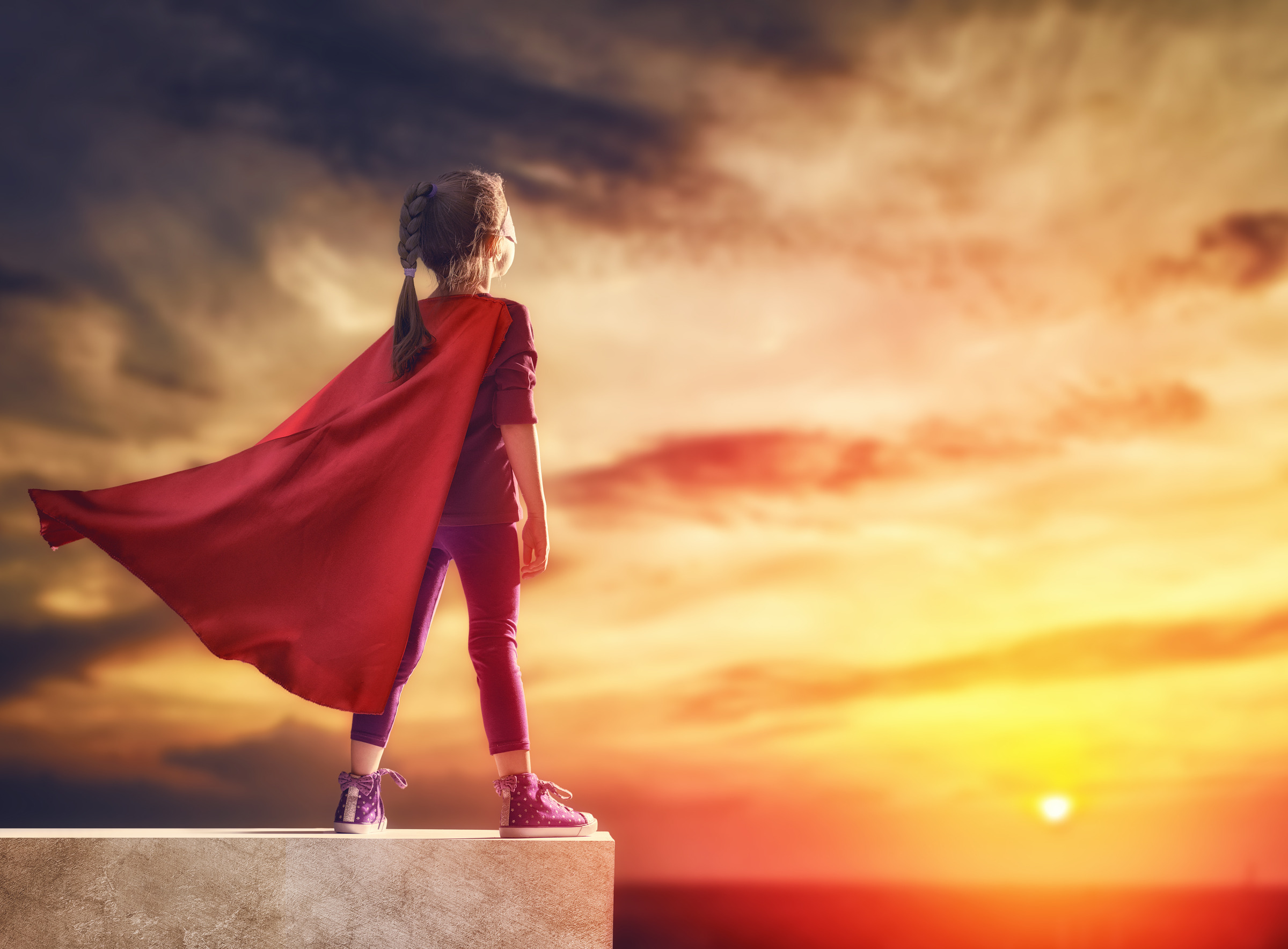 child plays superhero