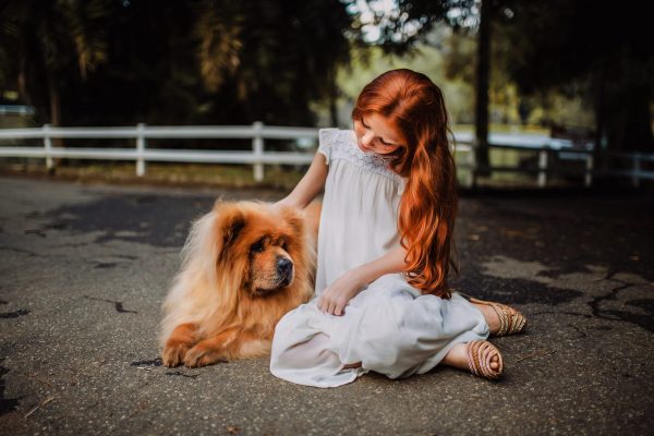 Canva - Woman Sitting Beside Chow Chow on Gray Concrete