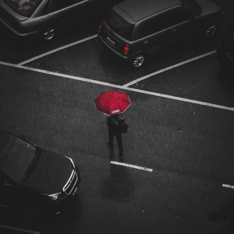 Canva - Person Holding Red Umbrella Walking on Street