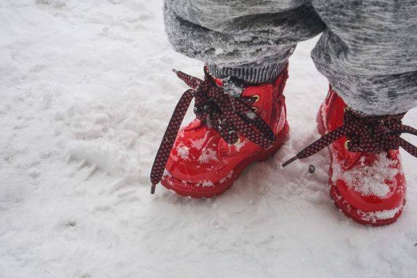 Canva - Toddler Wearing Red Shoes Standing On Snow