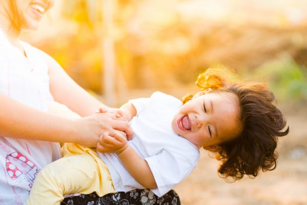 Canva - Woman Holding Baby Smiling